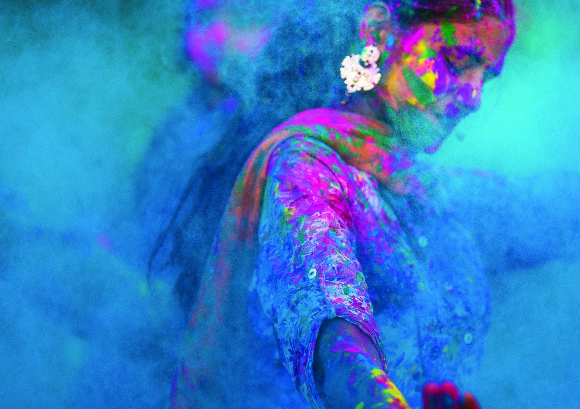 Background image used for promoting Corymbia Festival - woman doing a cultural dance in blue dust.