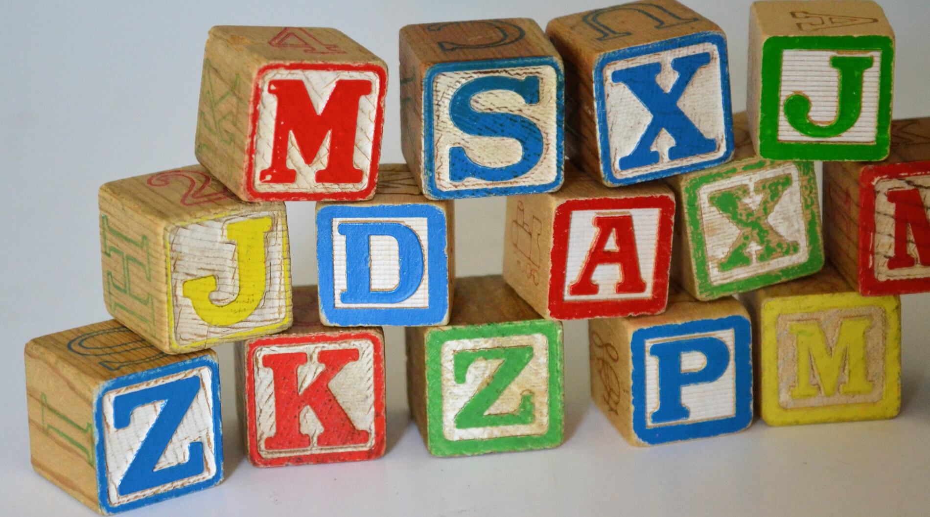 Children building blocks with letters