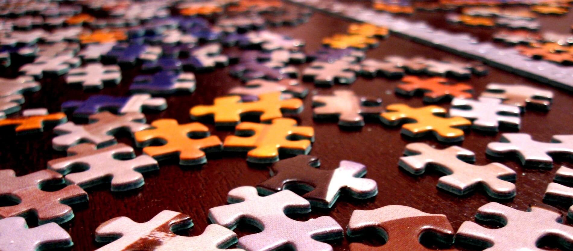 Jigsaw puzzle pieces on a wooden surface