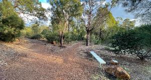 Seating along a footpath at Ray Owen behind the BMX track