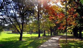 View on a foot path in Stirk Park heading towards the playground from Headingly Road