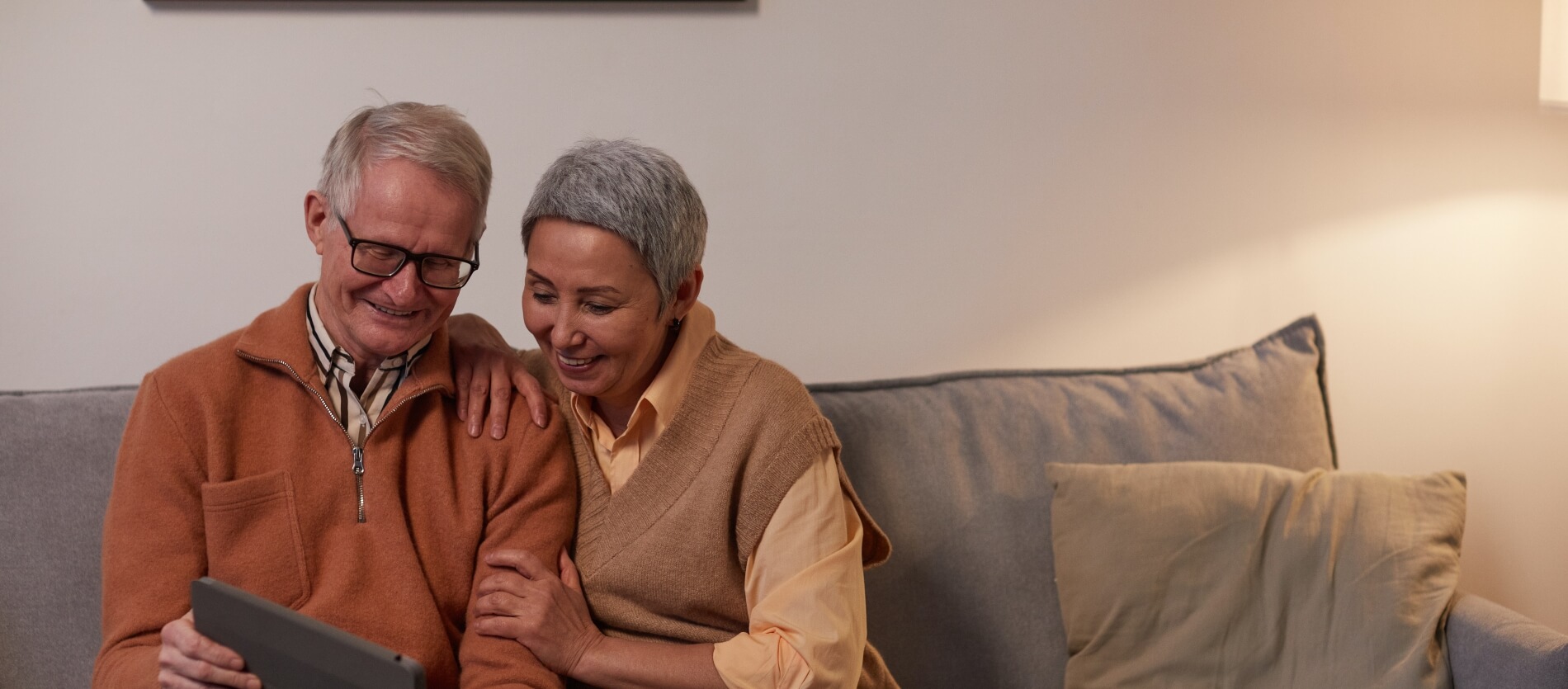 Elderly couple looking at a smart device