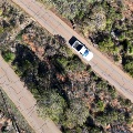 Aerial view of a white vehicle travelling down the Zig Zag Scenic Drive.